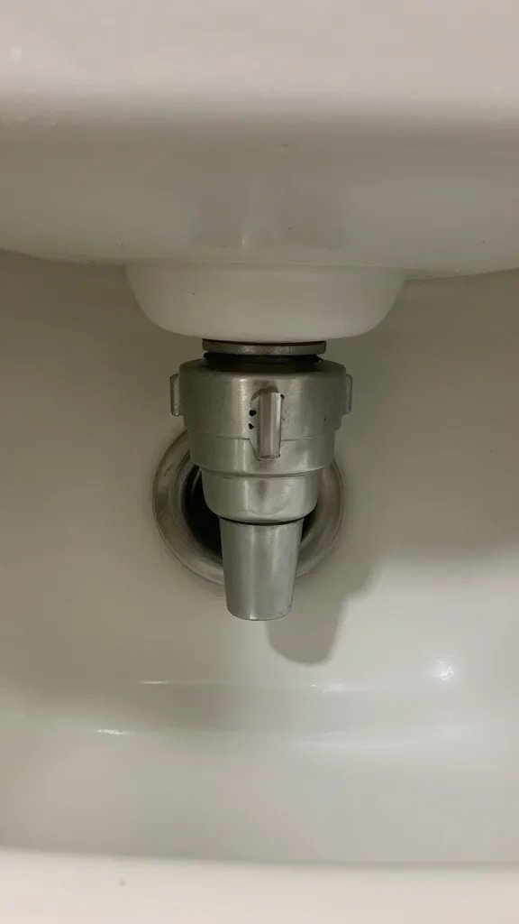 closeup of a P-trap under a laundry sink