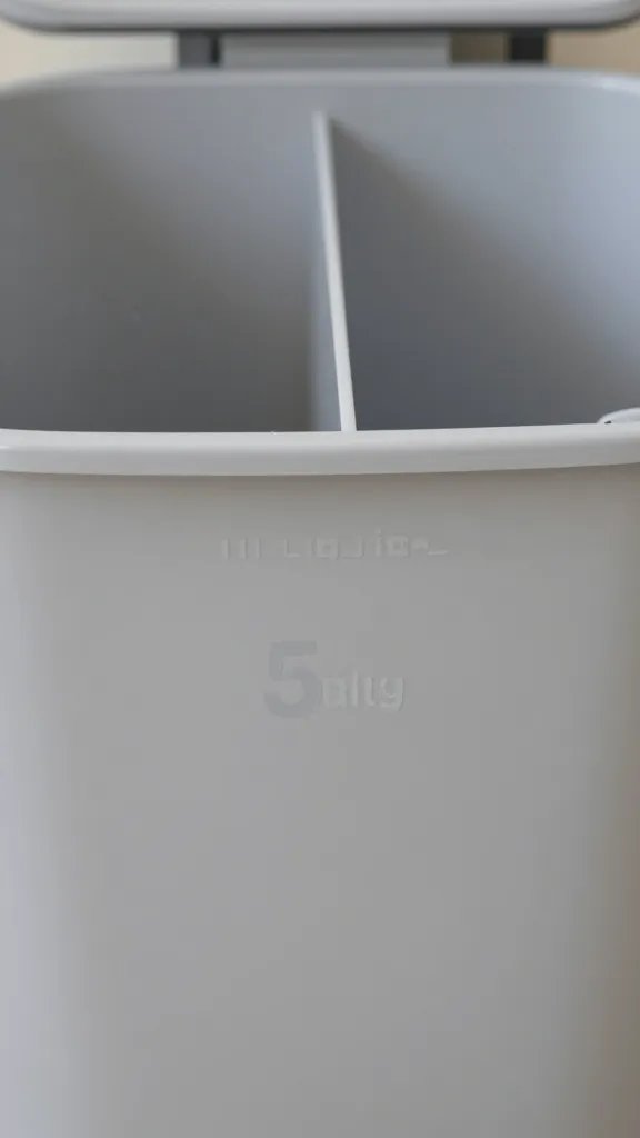 closeup of a labeled laundry sorting bin with separate sections